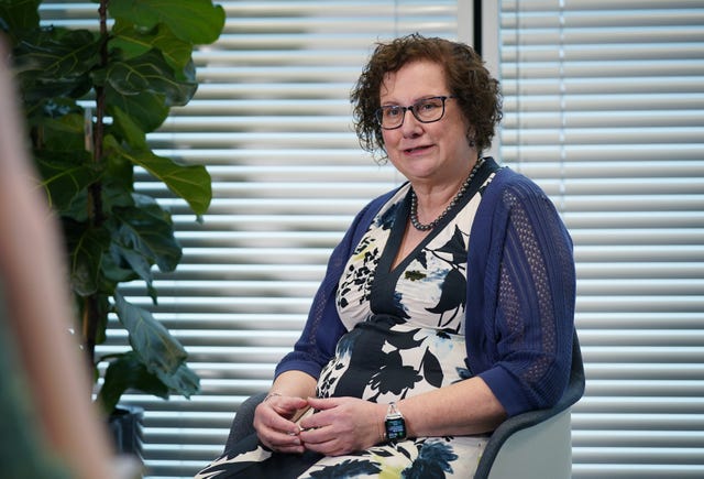 Woman sitting on chair in office for interview 