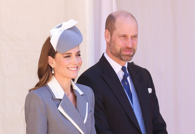 Kate smiling while standing next to William