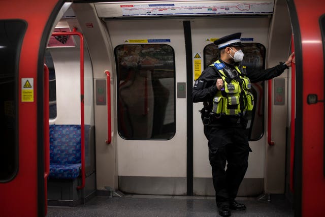 A British Transport Police officer wears a face mask on the Tube