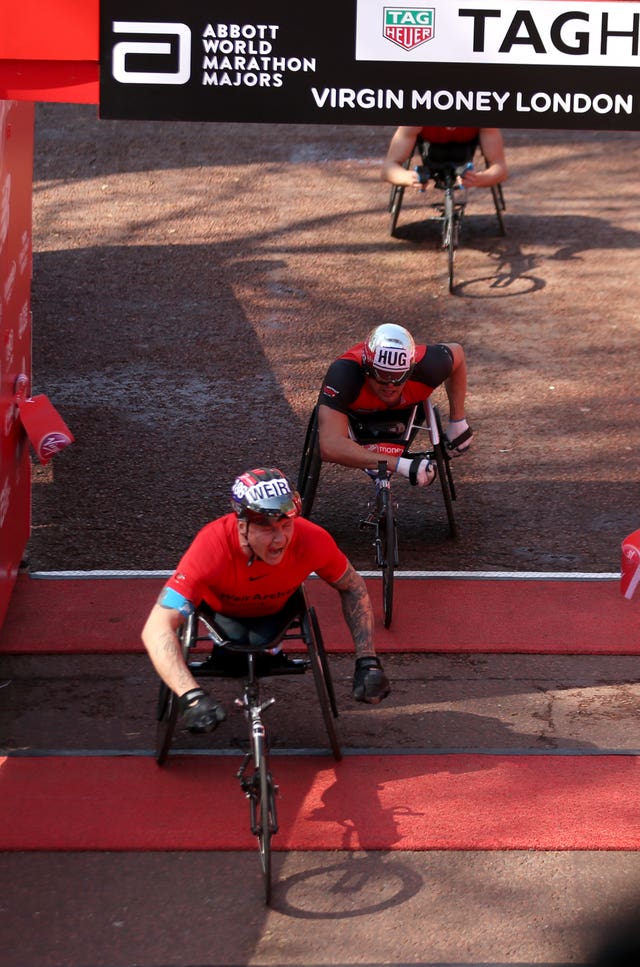 David Weir crosses the line to win the Men’s Wheelchair marathon (Paul Harding/PA)