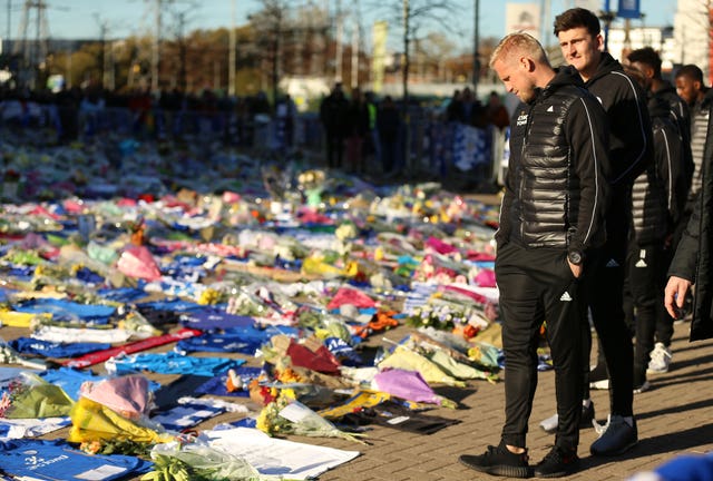Schmeichel and Harry Maguire look at the tributes outside the King Power Stadium