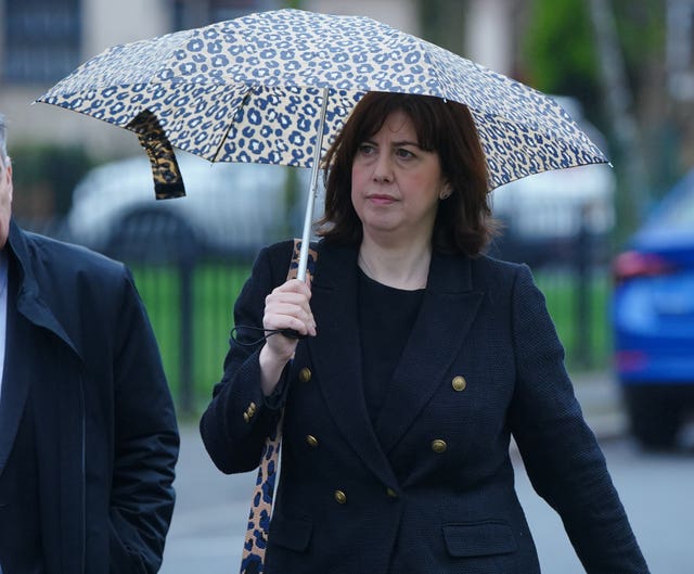 Lucy Powell carrying an umbrella