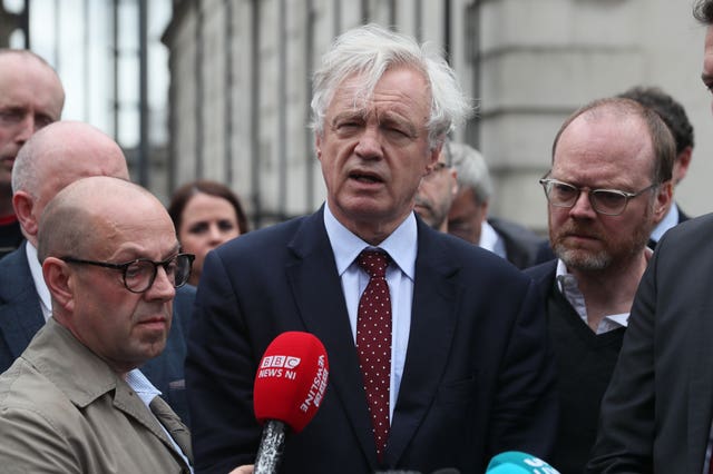 David Davis with journalists Trevor Birney and Barry McCaffrey outside the Royal Courts of Justice in Belfast