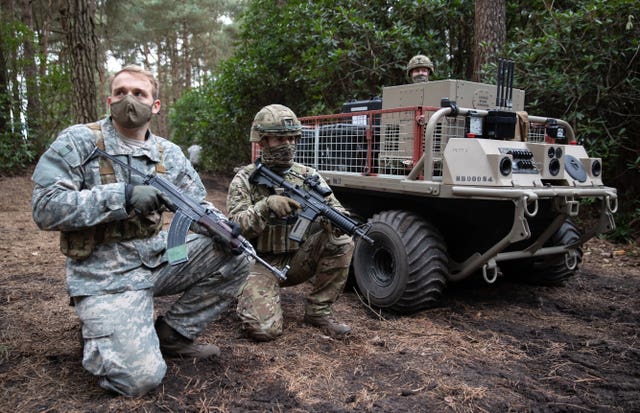 Members of the Army next to a utility delivery vehicle during a live exercise demonstration at Bovington Camp in Dorset 