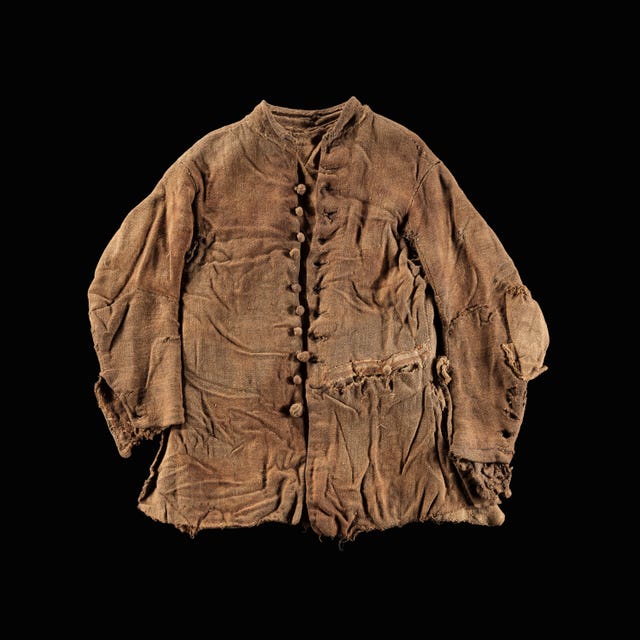 Brown jacket laid on black surface