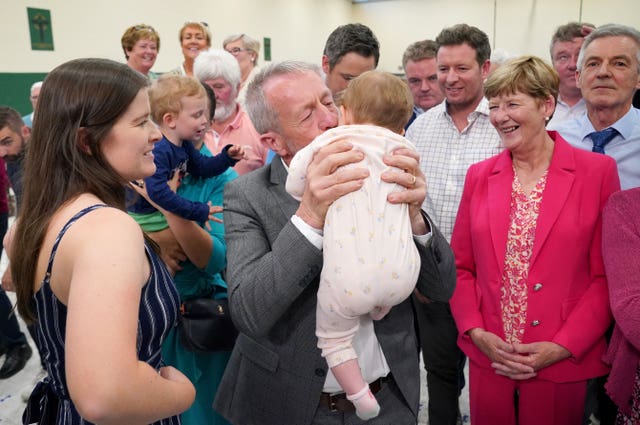 MEP Sean Kelly (centre) kisses his one-year-old granddaughter Hannah-Rose Kelly 
