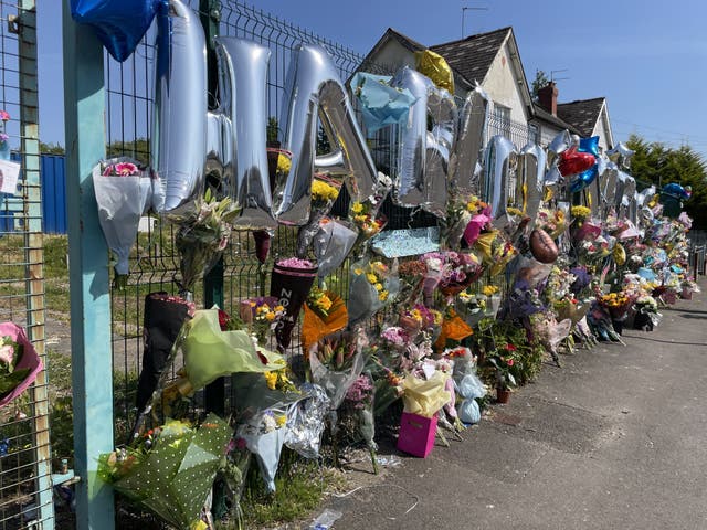 Hundreds of floral tributes and ballons have been left in Snowden Road to the two boys (Bronwen Weatherby/PA)