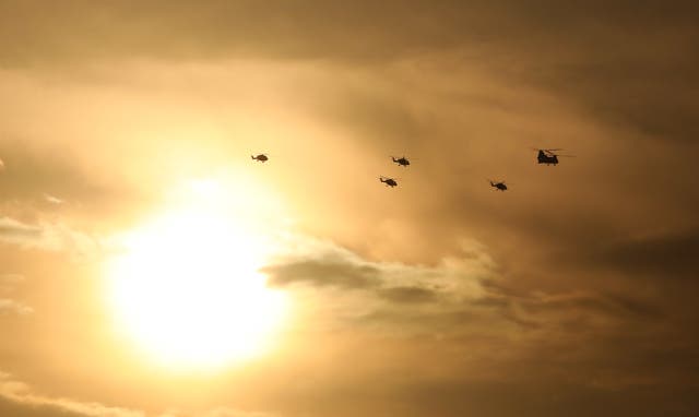 Helicopters are escorted by a Chinook (Philip Toscano/PA)