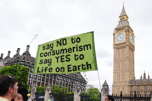 Protesters hold a banner near the Houses of Parliament