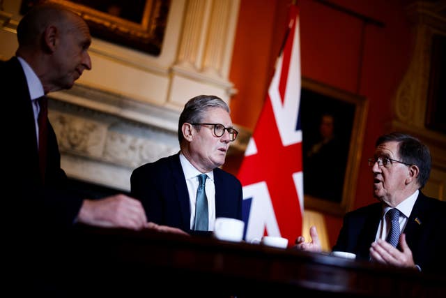 Sir Keir Starmer sitting at a desk, speaking to Lord Robertson who is on his left