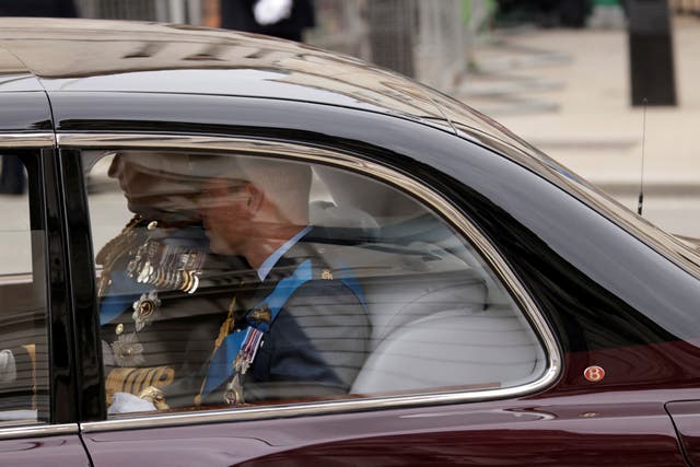 King Charles III, left, and the Duke of Sussex sit in a car ahead of the Queen's funeral