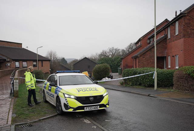 A police officer next to a police car