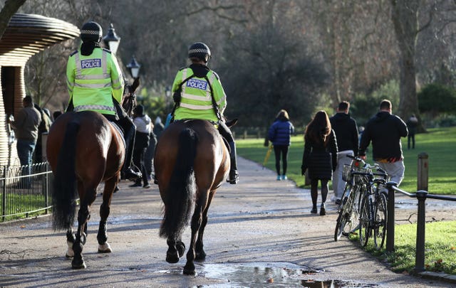 Police patrol on horseback through St James’ Park in London 