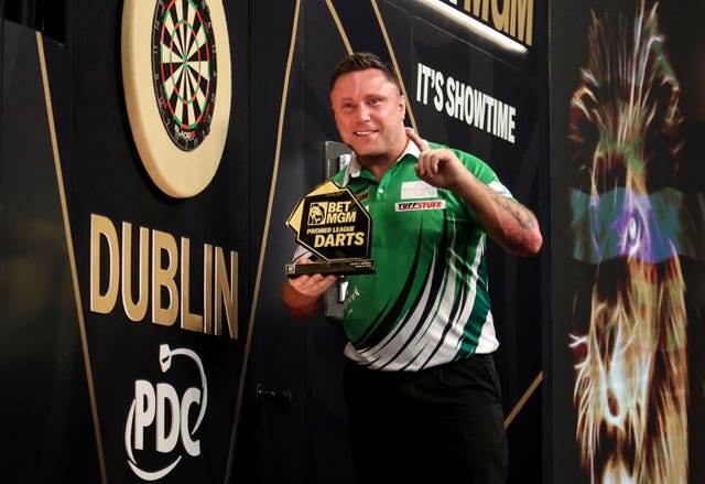 Gerwyn Price celebrates with the trophy after winning the final on night three of the 2025 Premier League in Dublin