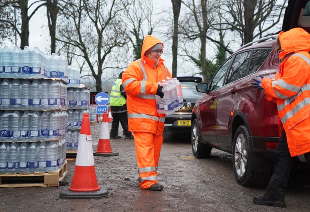 South East Water staff handing out bottled water at a water station in Maidstone, Kent