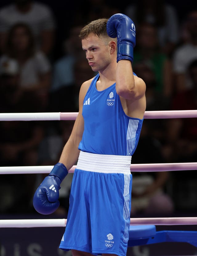 Lewis Richardson, in blue, in the boxing ring. 