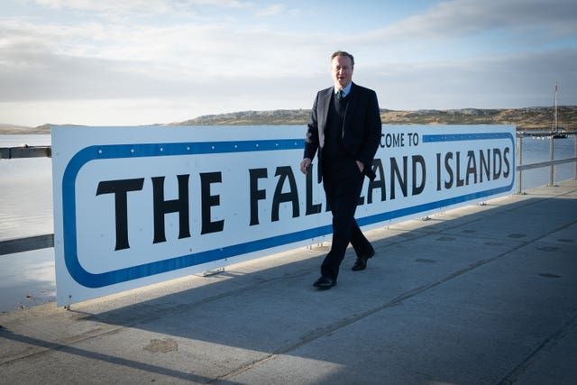 Foreign Secretary Lord David Cameron walks around Port Stanley on the Falkland Islands