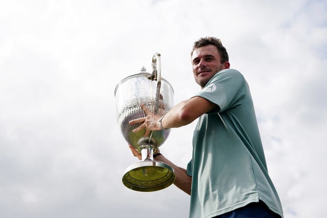 Tommy Paul holds the trophy at Queen's Club 