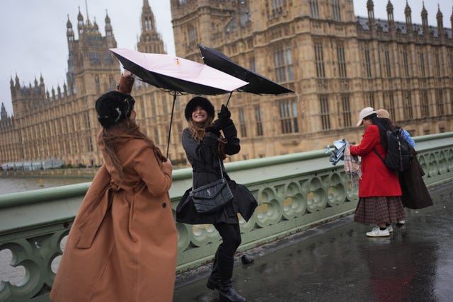 People in the rain on Westminster Bridge, London