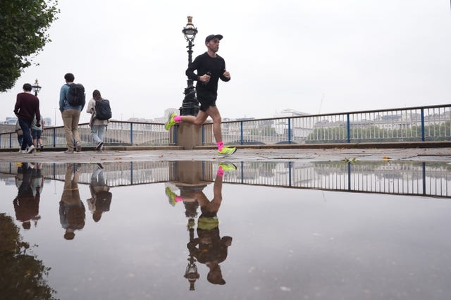 Person running on a wet street