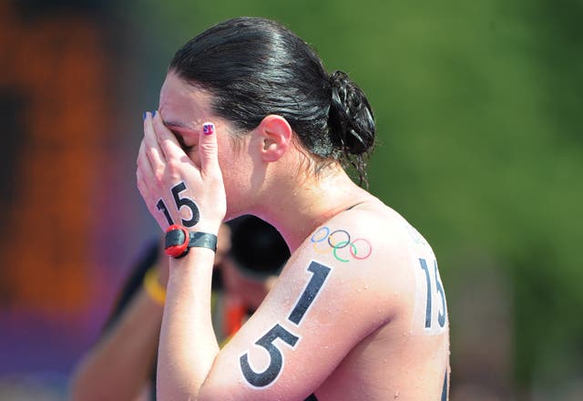 Keri-Anne Payne puts her hand over her face in disappointment after finishing fourth at the London Olympics