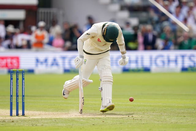 The injured Nathan Lyon completes a single against England