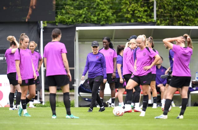Head coach Sarina Wiegman, centre, with her England players during Saturday's training session