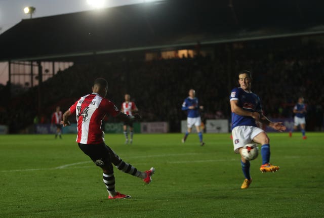 Ollie Watkins, left, scores for Exeter against Carlisle in 2017