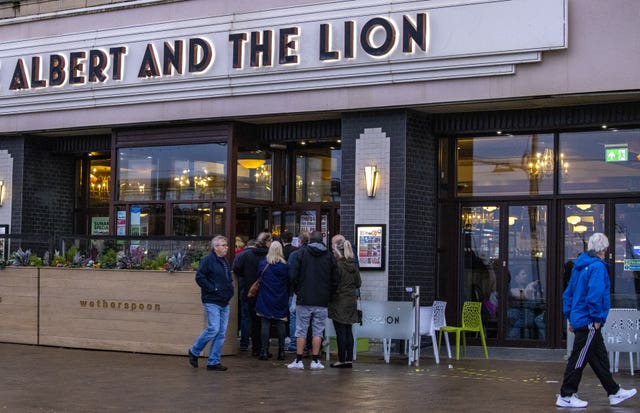 People queue outside a Wetherspoons pub in Blackpool