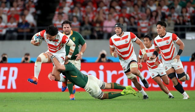 Japan’s Keita Inagaki, left, is tackled during the World Cup quarter-final
