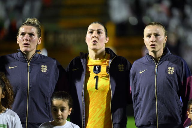 England's Millie Bright, Mary Earps and Leah Williamson, left to right, line up for the national anthem