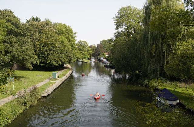 People kayak along the Thames in Hurley, Berkshire