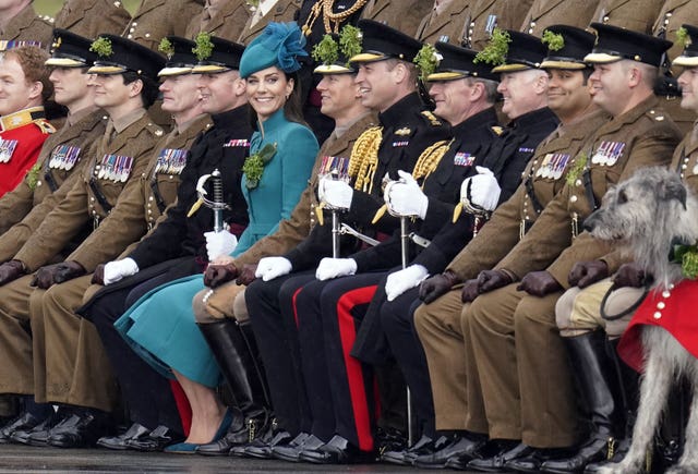 The Princess of Wales turns her head to look at the camera as the Prince of Wales and soldiers look straight ahead during their visit to the 1st Battalion Irish Guards for the St Patrick’s Day Parade at Mons Barracks in Aldershot in 2023 