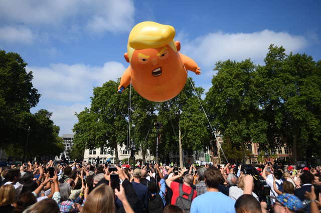 A ‘Baby Trump’ balloon rises after being inflated in London’s Parliament Square, as part of the protests against the visit of US President Donald Trump to the UK.