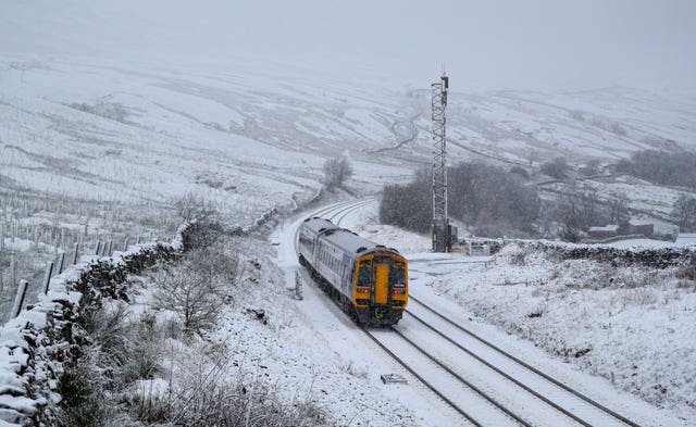 A train runs along the track (Peter Byrne/PA)