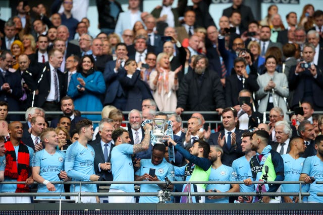 David Silva, centre right, lifts the FA Cup with Kyle Walker, centre left