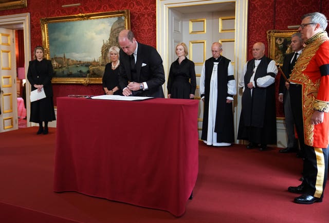 The Prince of Wales signs the Proclamation of Accession of King Charles III, watched by, left-right back, Lord President of the Council Penny Mordaunt, the Queen Consort, Prime Minister Liz Truss, Archbishop of Canterbury Justin Welby, Archbishop of York Stephen Cottrell, Lord Chancellor of the Privy Council Brandon Lewis and Earl Marshal, Edward Fitzalan-Howard, the Duke of Norfolk, during the Accession Council ceremony at St James’s Palace, London, where King Charles III is formally proclaimed monarch on September 10