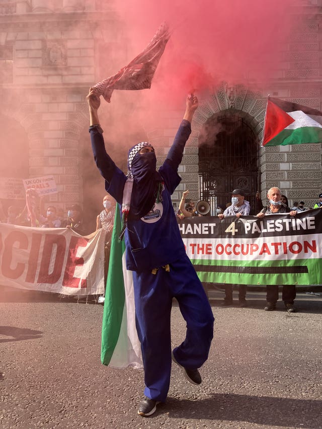 A protester lets off a flare