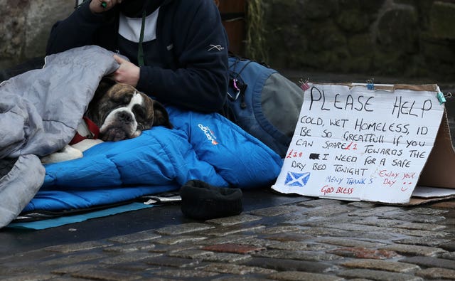 A homeless person and their dog in Edinburgh