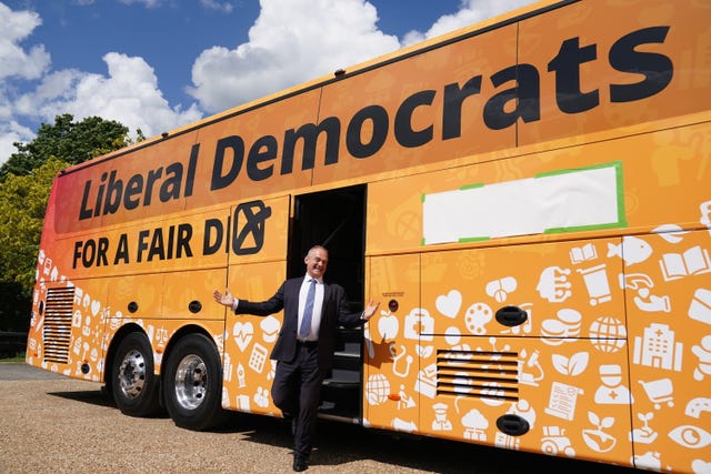 Liberal Democrat leader Sir Ed Davey in front of the Lib Dem bus