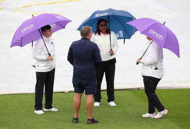 Umpires discuss the conditions at Taunton