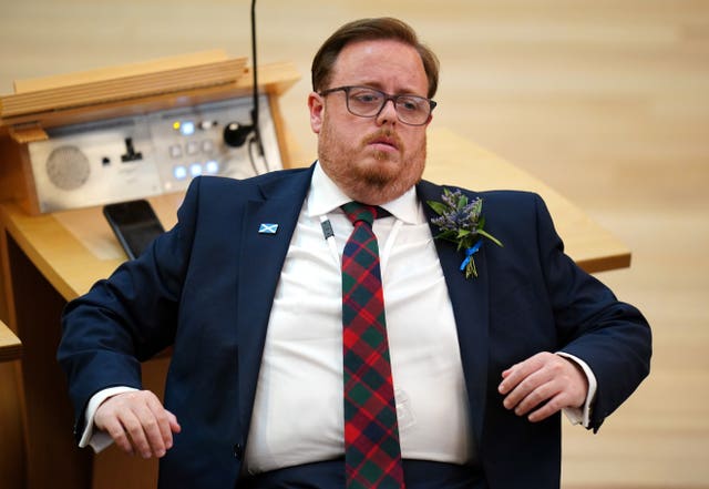 Thomas Kerr sits in the Scottish Parliament chamber
