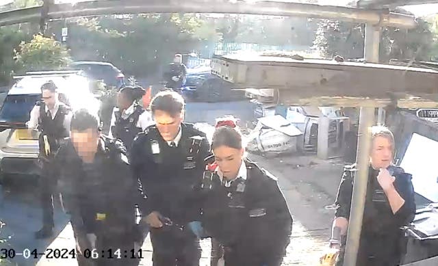 Police officers after tasering and detaining a man