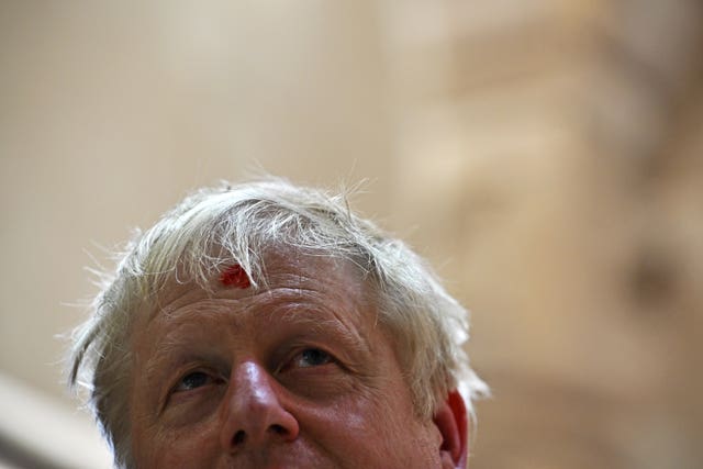 Prime Minister Boris Johnson looks on with his forehead marked by a traditional ’tilak’ as he visits the Swaminarayan Akshardham temple in Gandhinagar, Ahmedabad, as part of his two day trip to India on Thursday April 21 2022