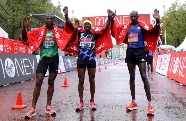 Ethiopia’s Shura Kitata (centre) celebrates victory alongside second-placed  Vincent Kipchumba of Kenya (right) and third-placed Sisay Lemma of Ethiopia