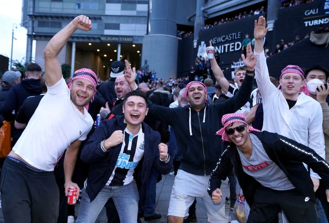 Newcastle fans celebrate the Saudi-led takeover in October 2021