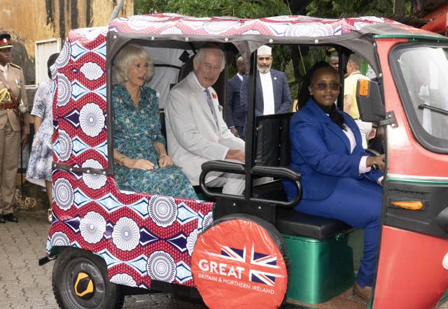 Charles and Camilla sitting in the back of a tuk-tuk