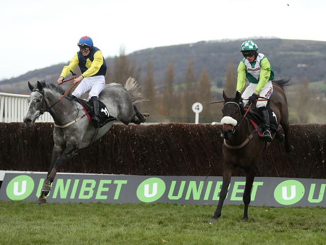 Guitar Pete (left) jumps the last fence en route to success in the Caspian Caviar Gold Cup at Cheltenham