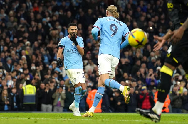 Riyad Mahrez (left) celebrates his penalty