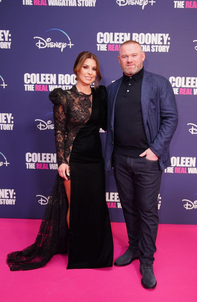Coleen and Wayne Rooney posing for photos at the premiere of The Real Wagatha Story